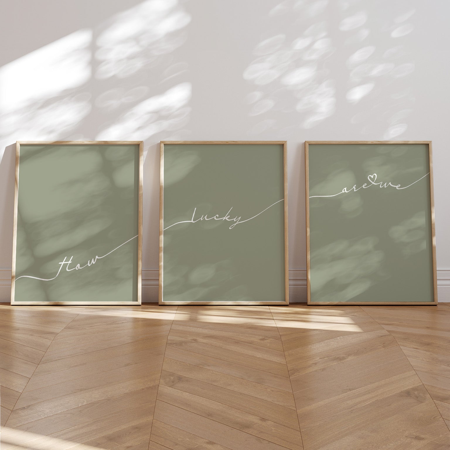 Set of 3 preppy aesthetic sage green posters with cursive text “How Lucky Are We” in white. Perfect for motivational gallery walls or above-the-bed decor.  