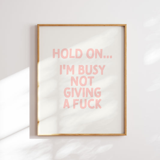 Trendy printable wall art poster featuring a  "I'm busy not giving a fuck" text in a stylish cream and peach pink design. Perfect for adding a touch of cool humor to any room or as a unique gift. Instantly downloadable and easy to print at home or through a professional service.
Shop unique wall art by WonkyWonder now.