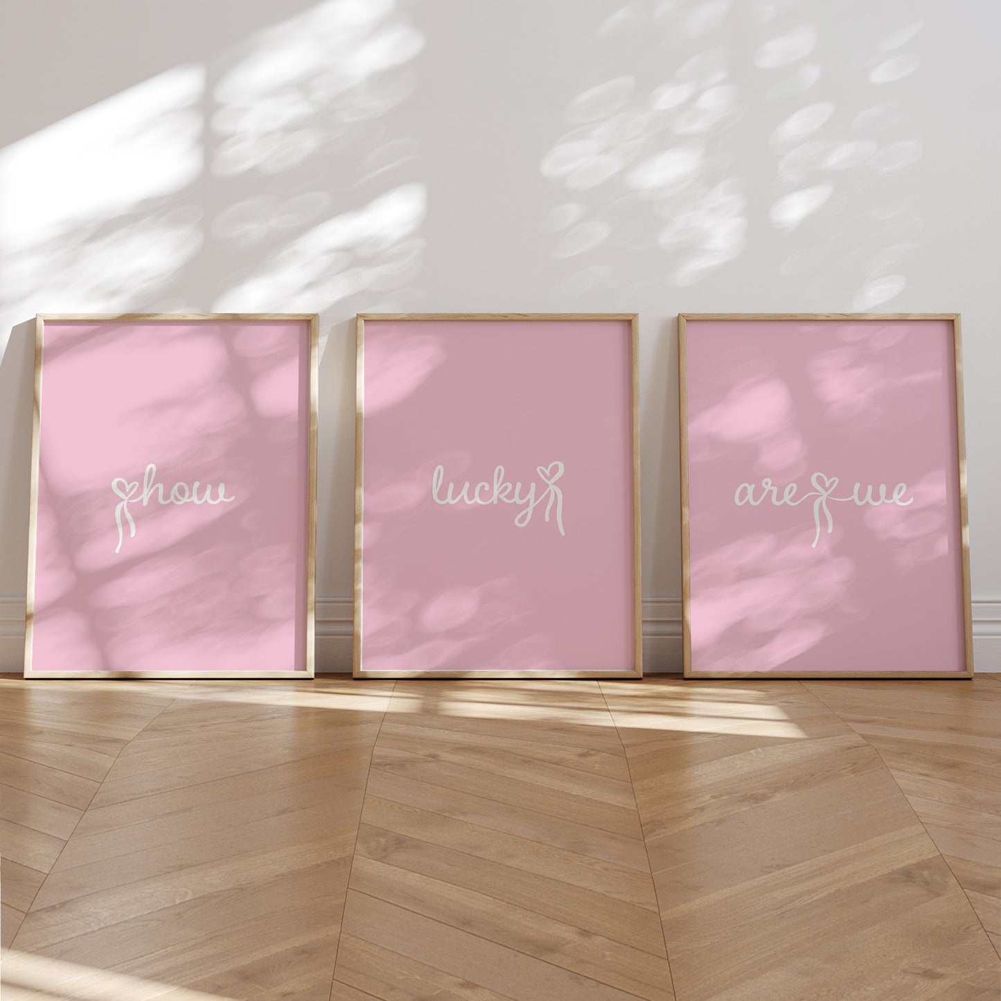 Set of 3 aesthetic pink posters with cursive text reading “How Lucky Are We” in white. Digital download wall art for a stylish gallery setup. 