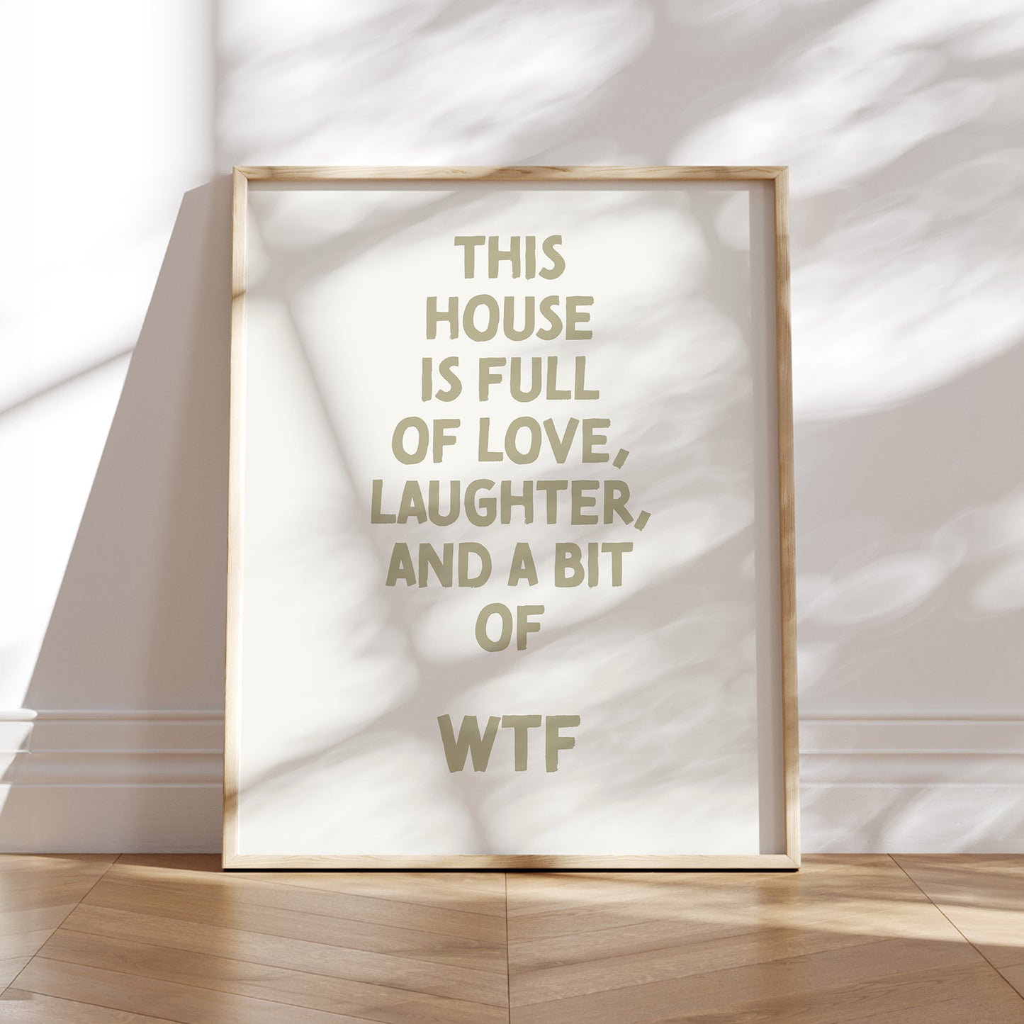 Trendy printable wall art poster featuring a  ""This house is full of love, laughter and a bit of wtf"" text in a stylish cream and boho olive green design. Perfect for adding a touch of cool humor to any room or as a unique gift. Instantly downloadable.
Shop unique wall art now by WonkyWonder.